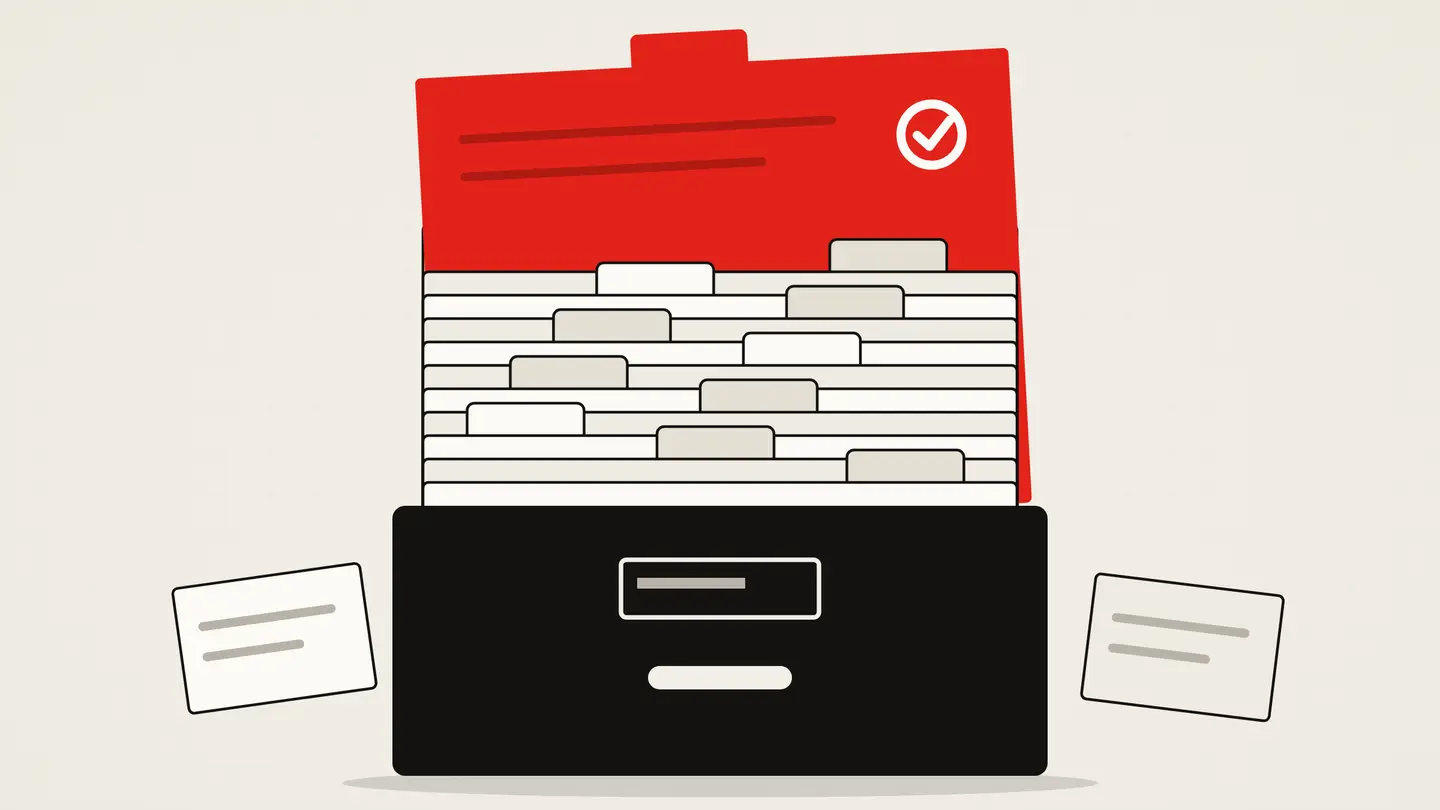 A drawer of index cards seen from the front; one red card is pulled up above the rest